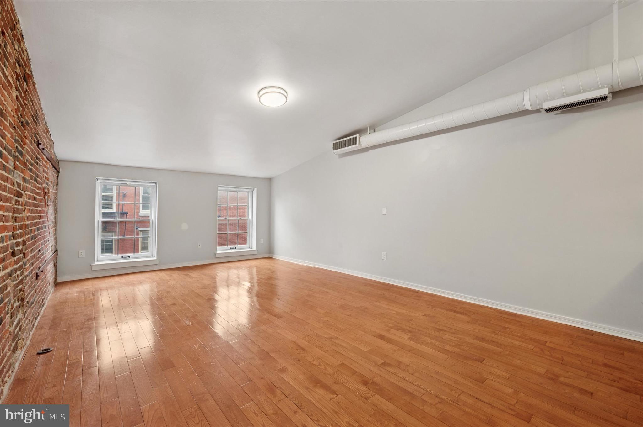 222 Church Street, Unit 2J Philadelphia, PA 19106 - Photo 13 of 17 wooden floor in an empty room with a window