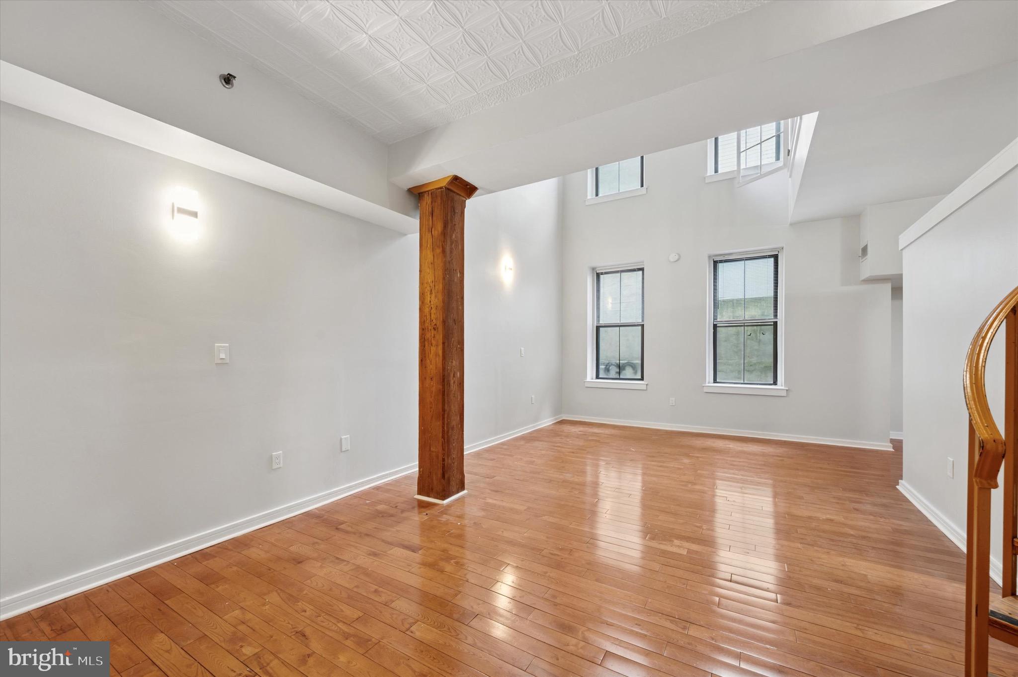 222 Church Street, Unit 2J Philadelphia, PA 19106 - Photo 17 of 17 a view of an empty room with window and wooden floor