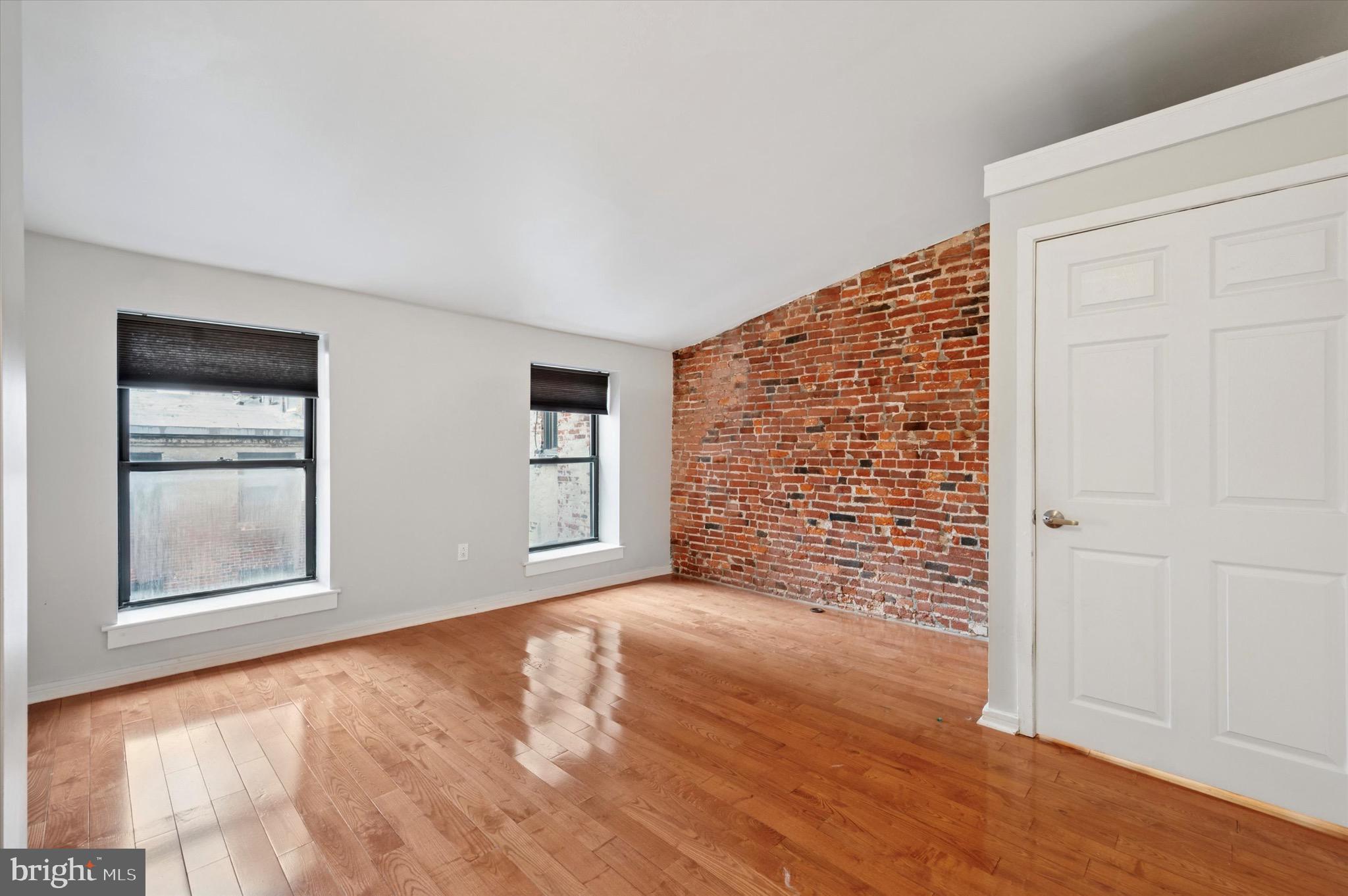 222 Church Street, Unit 2J Philadelphia, PA 19106 - Photo 6 of 17 an empty room with windows and closet