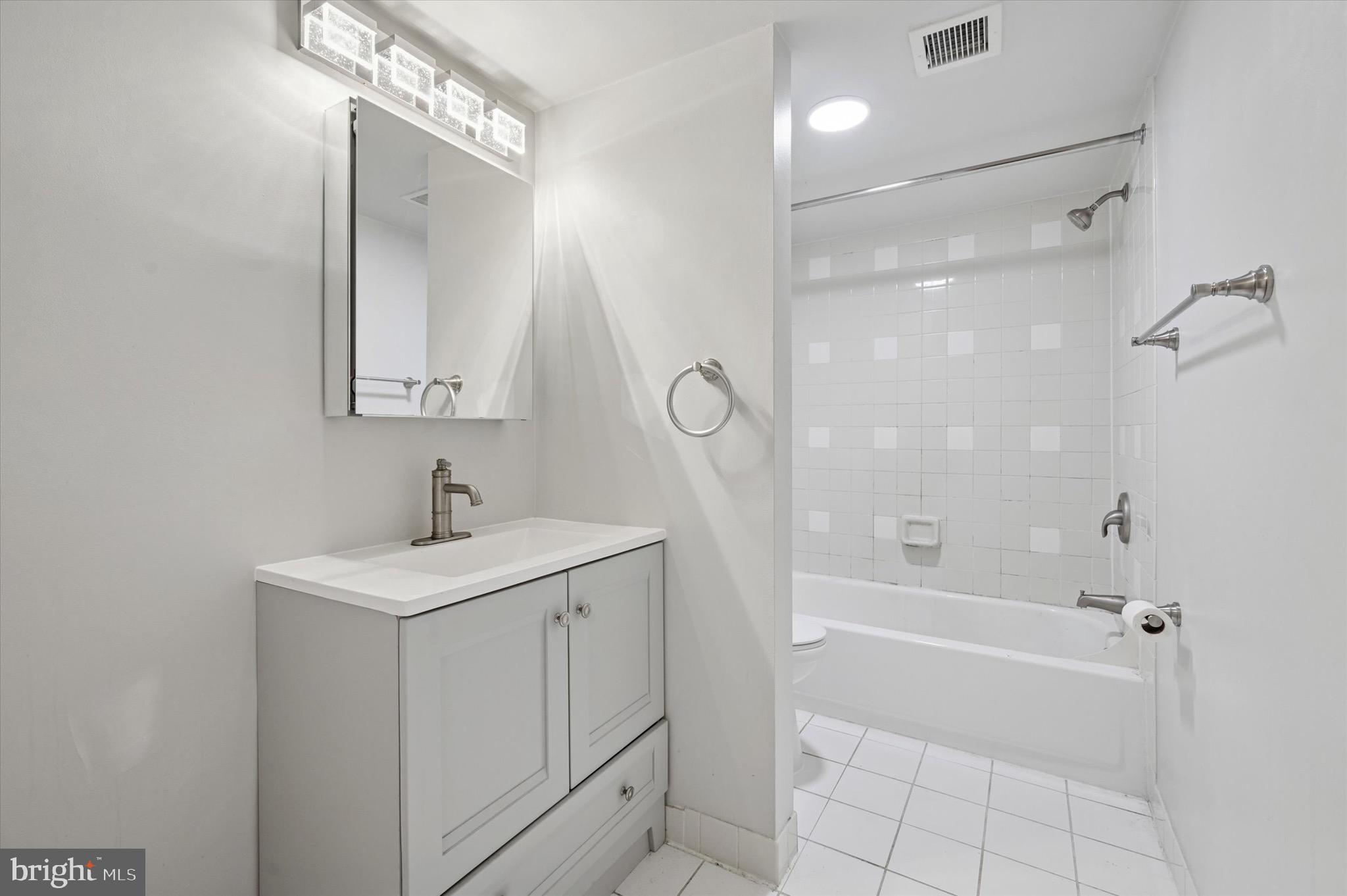 222 Church Street, Unit 2J Philadelphia, PA 19106 - Photo 8 of 17 a bathroom with a sink a toilet and shower