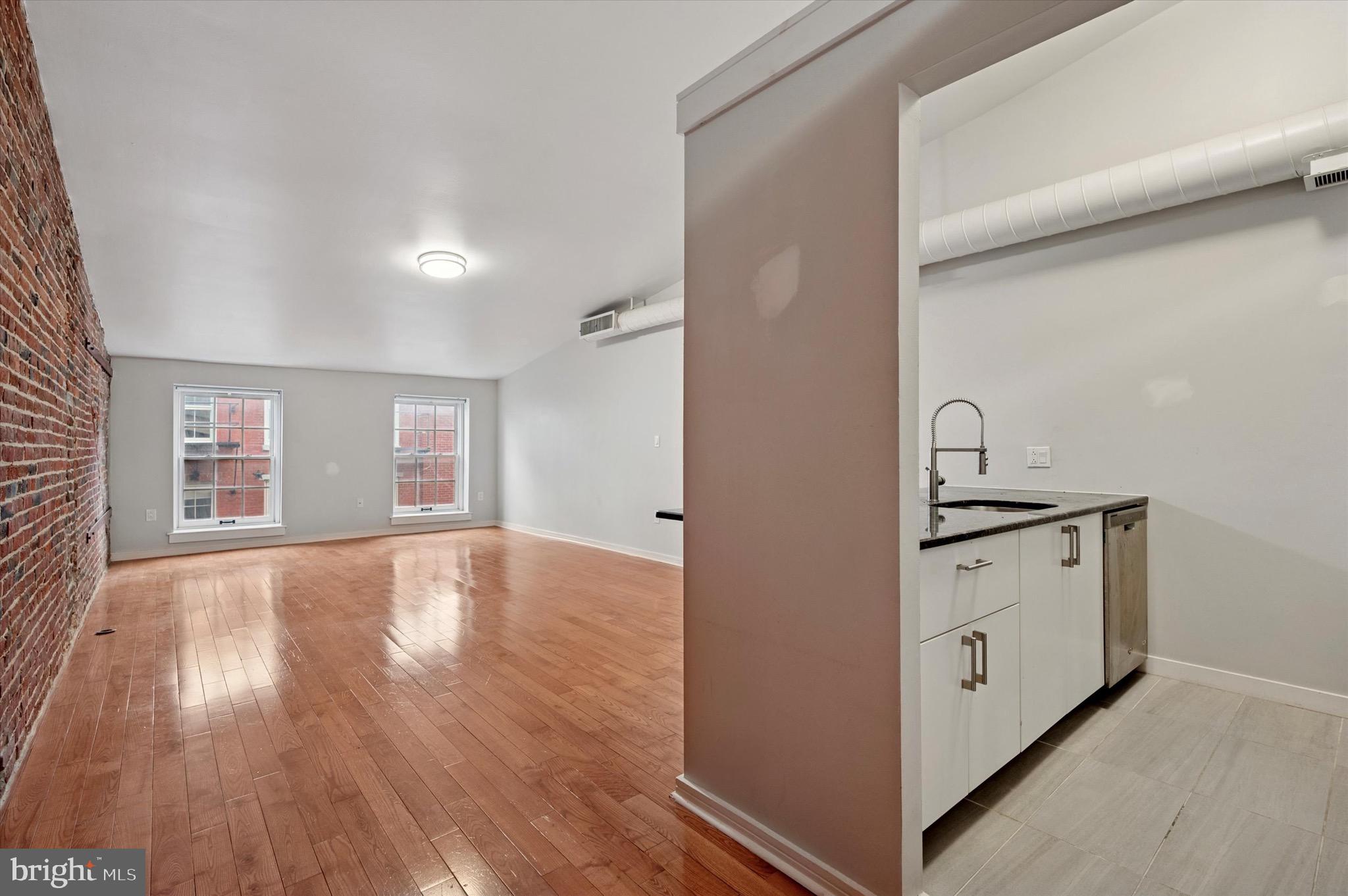 222 Church Street, Unit 2J Philadelphia, PA 19106 - Photo 10 of 17 a view of a kitchen with wooden floor and a sink
