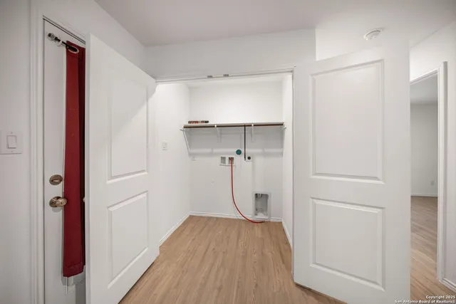a view of a room with wooden floor