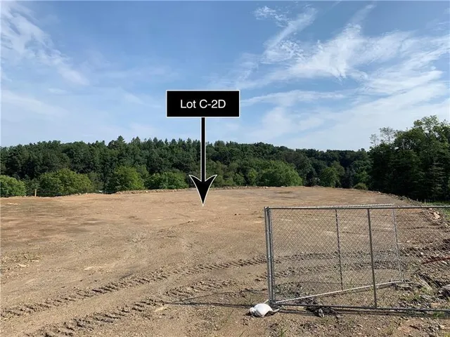 a sign board with tall trees