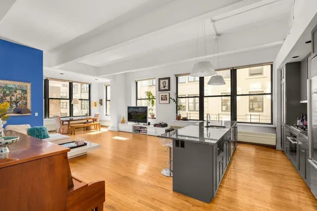 a living room with fireplace furniture and a large window