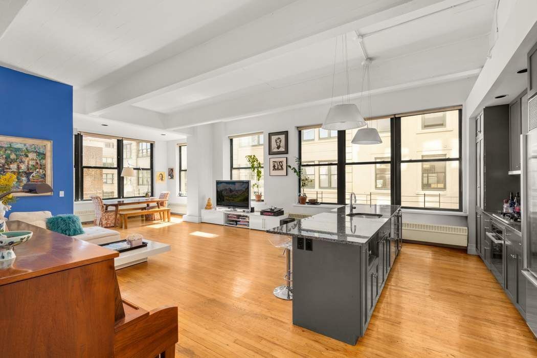 a living room with fireplace furniture and a large window