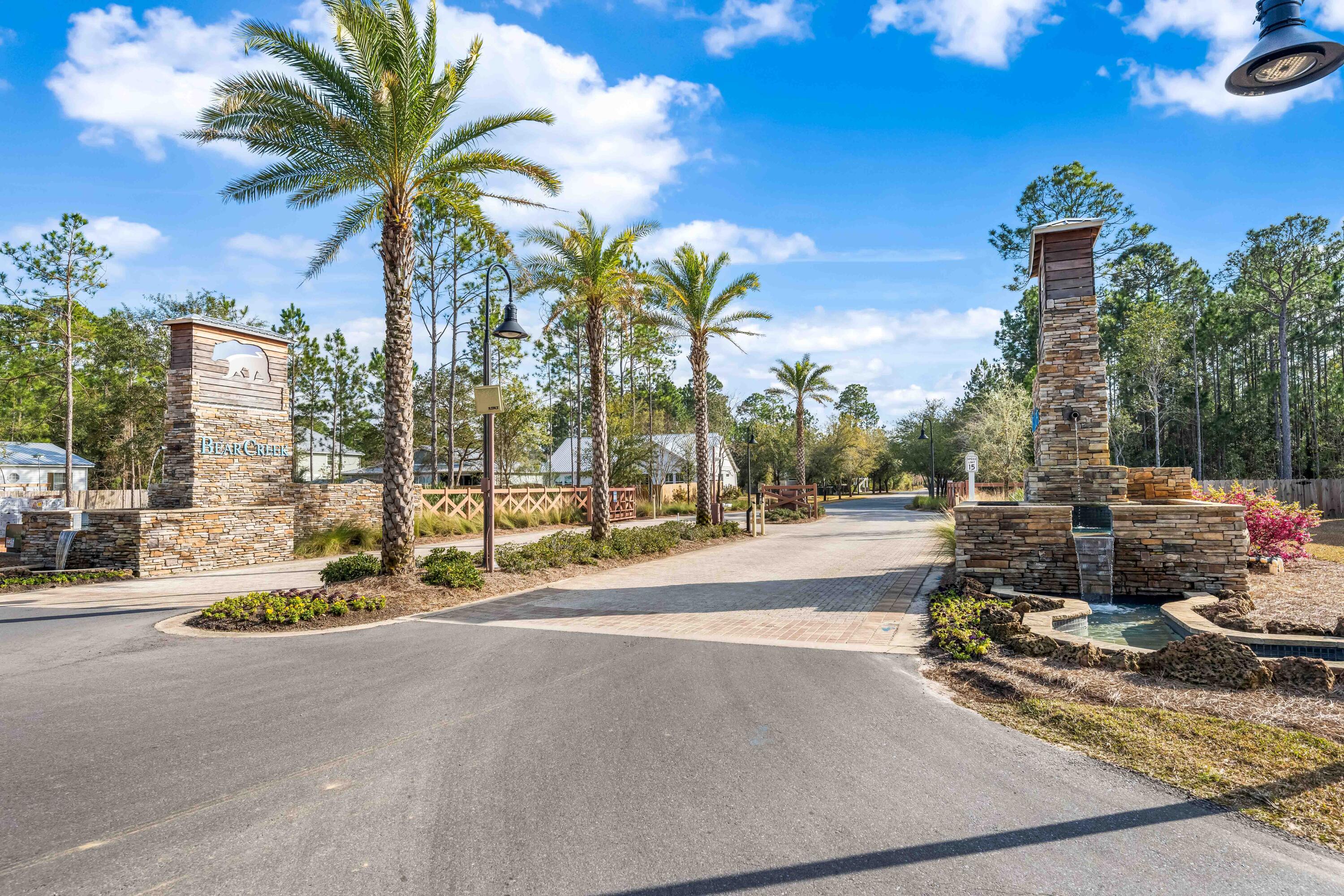 Lot 51 Muzzle Street Freeport, FL 32439 - Photo 22 of 26 a row of palm trees and swimming pool in the backyard of building