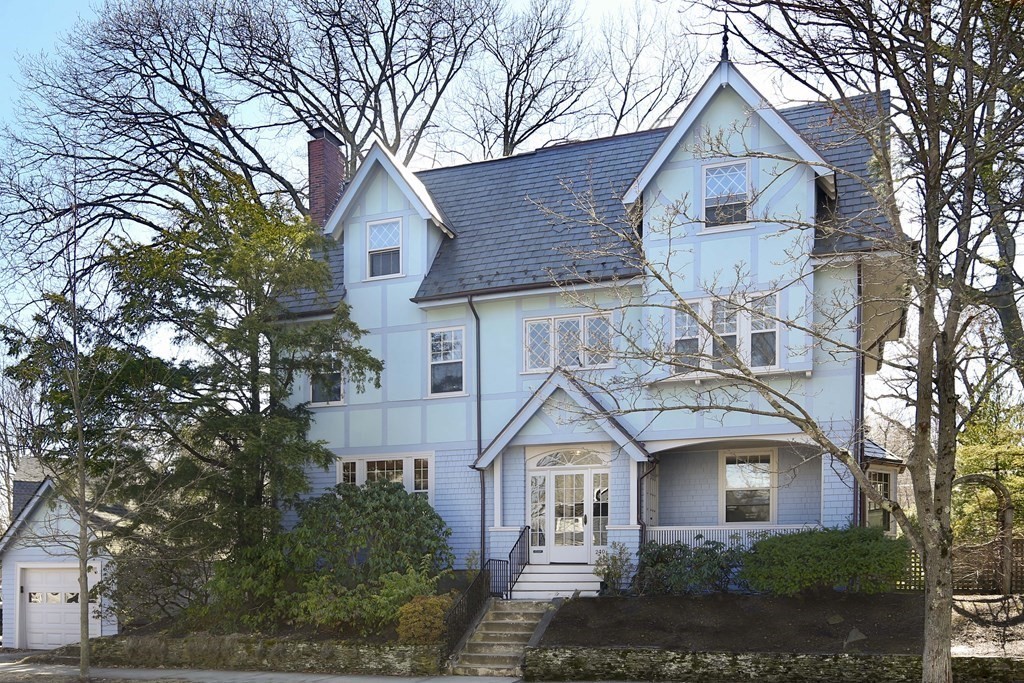 240 Clinton Road Brookline, MA 02445 - Photo 1 of 24 a front view of a house with a yard and trees