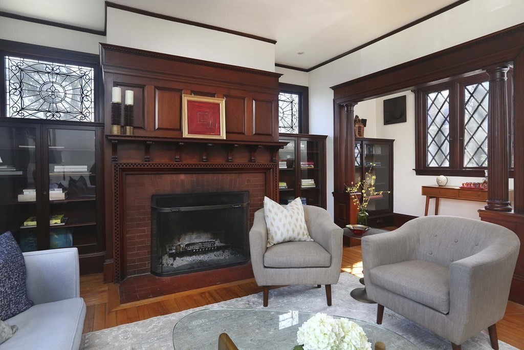 240 Clinton Road Brookline, MA 02445 - Photo 7 of 24 a living room with furniture a window and a fireplace