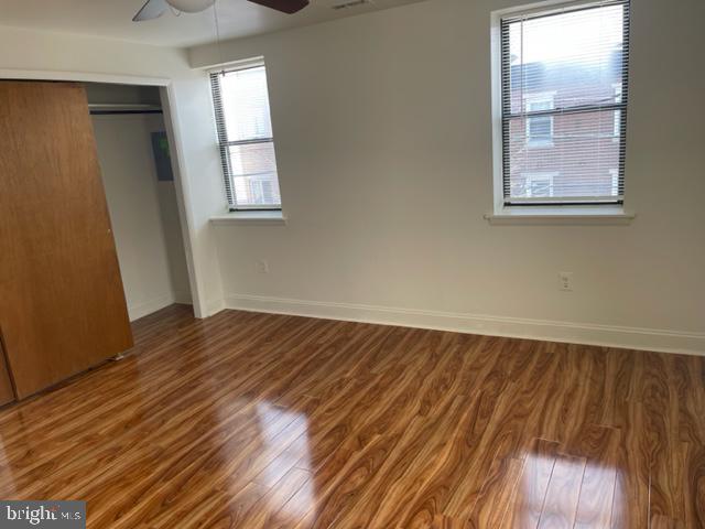 922 South 19th Street, Unit 3 Philadelphia, PA 19146 - Photo 2 of 6 an empty room with wooden floor and windows
