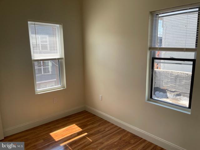 922 South 19th Street, Unit 3 Philadelphia, PA 19146 - Photo 4 of 6 a view of an empty room with wooden floor and a window