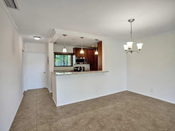 a view of a kitchen with chandelier