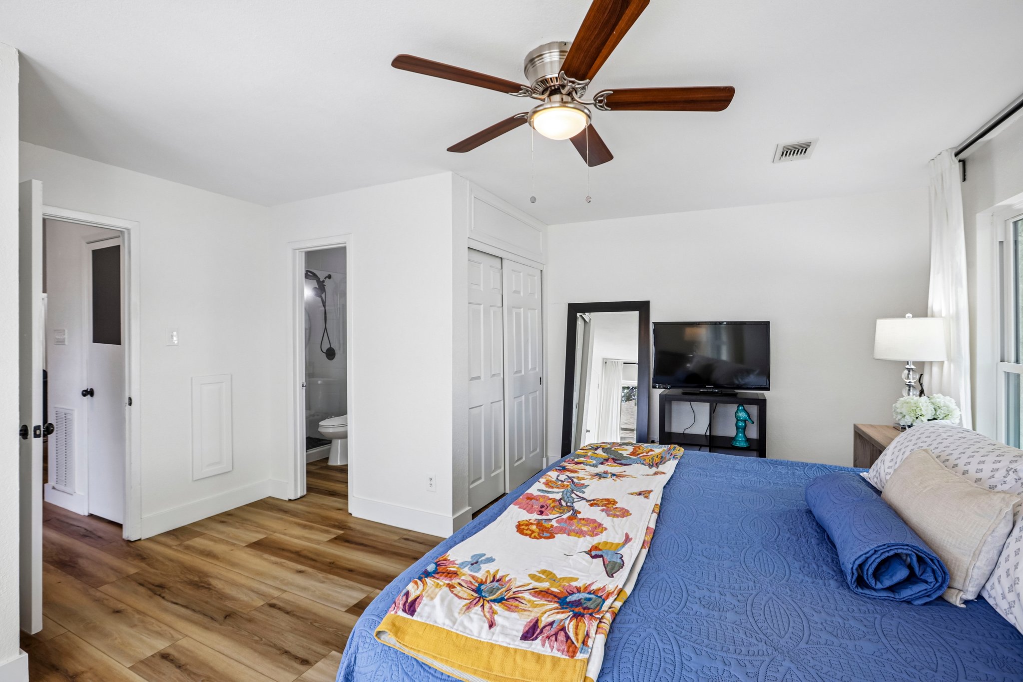 16725 Whitebrush Loop Austin, TX 78717 - Photo 21 of 32 A tranquil sleeping space showcasing natural wood flooring and an attached bathroom entrance.