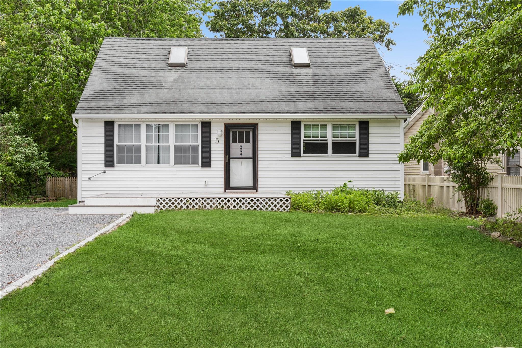 5 Coolidge Road Hampton Bays, NY 11946 - Photo 1 of 1 a front view of a house with a garden