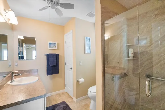 a bathroom with a sink toilet a mirror and shower