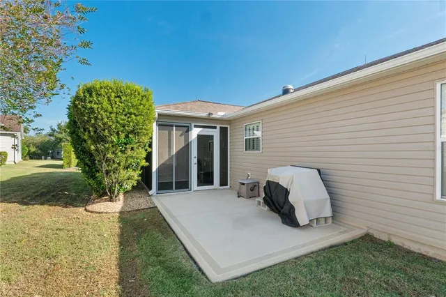a view of backyard of house with green space