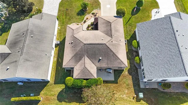an aerial view of a house with a yard