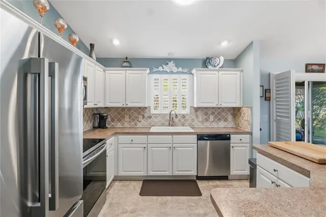 a kitchen with a sink stove and refrigerator