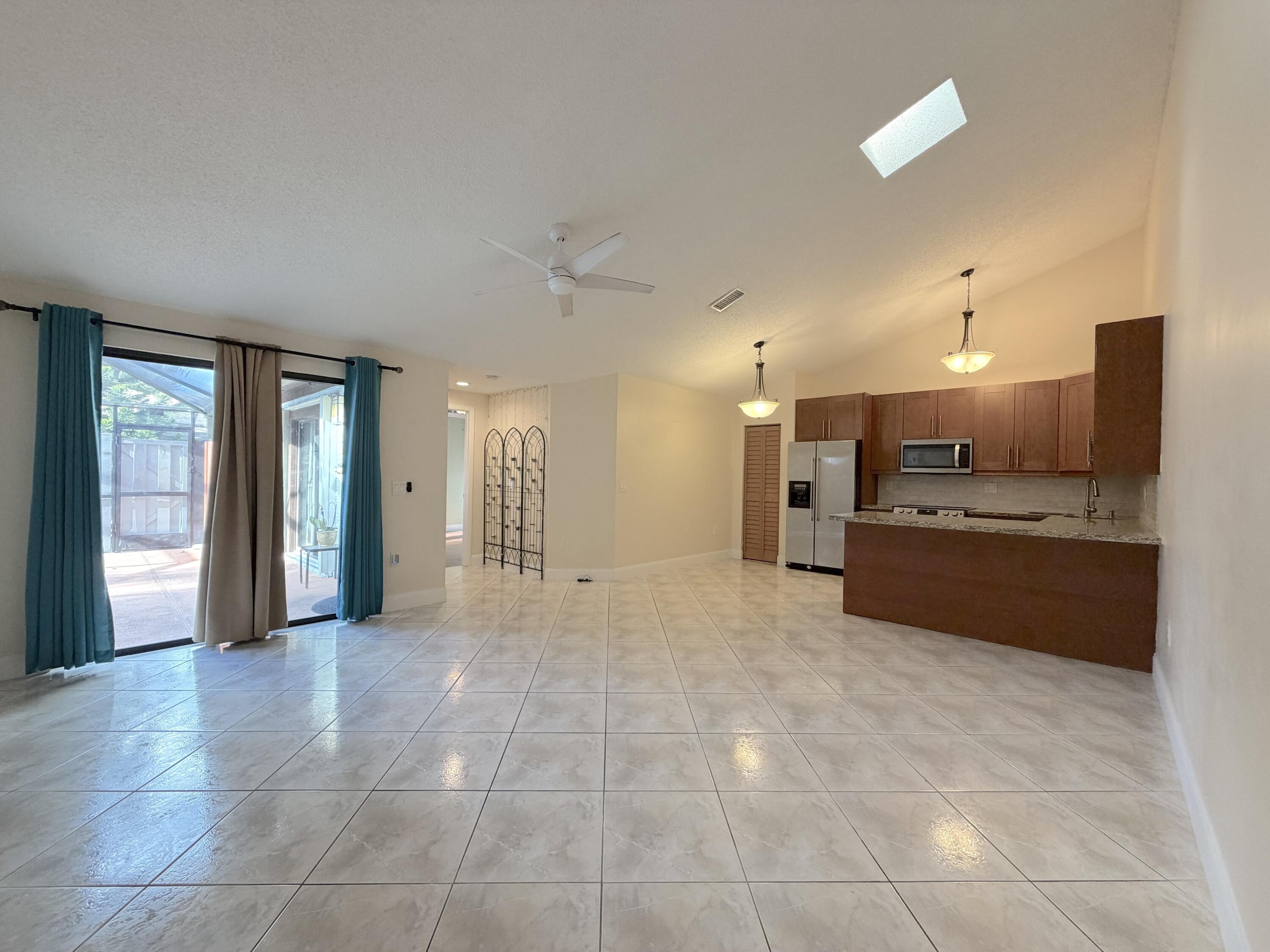 9927 Boca Gardens Trail, Unit A Boca Raton, FL 33496 - Photo 16 of 63 a view of a kitchen with a sink and a window