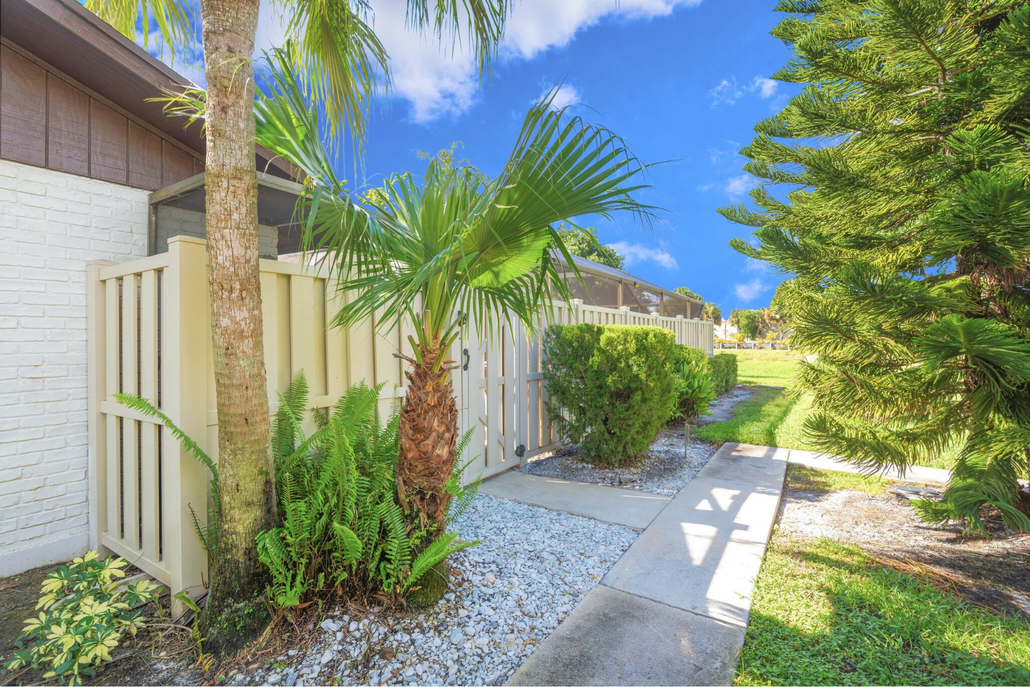 9927 Boca Gardens Trail, Unit A Boca Raton, FL 33496 - Photo 2 of 63 a view of a palm trees front of house