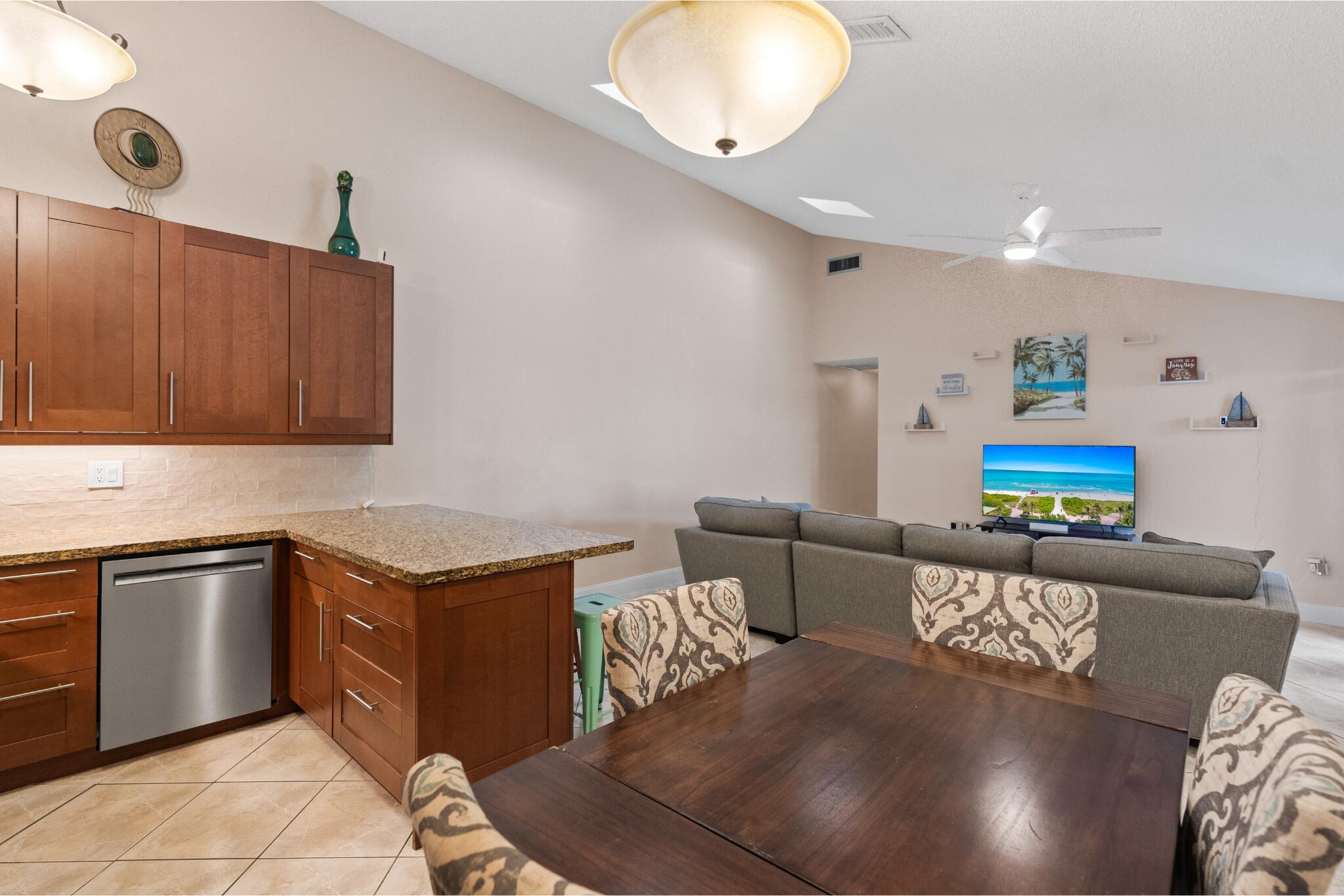 9927 Boca Gardens Trail, Unit A Boca Raton, FL 33496 - Photo 21 of 63 a kitchen with stainless steel appliances granite countertop a sink and a stove