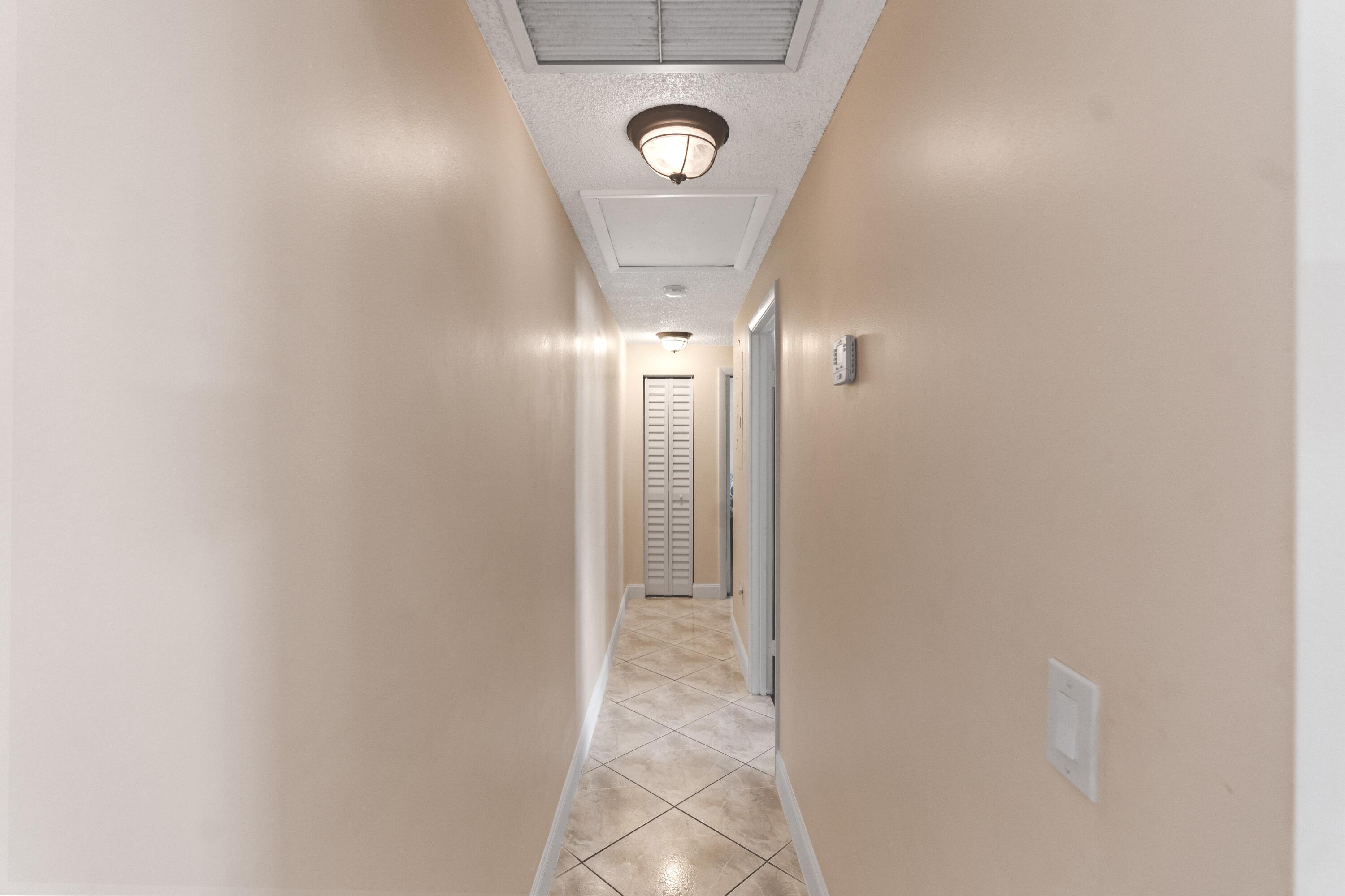 9927 Boca Gardens Trail, Unit A Boca Raton, FL 33496 - Photo 29 of 63 Hallway to Bedroom 2 and 3