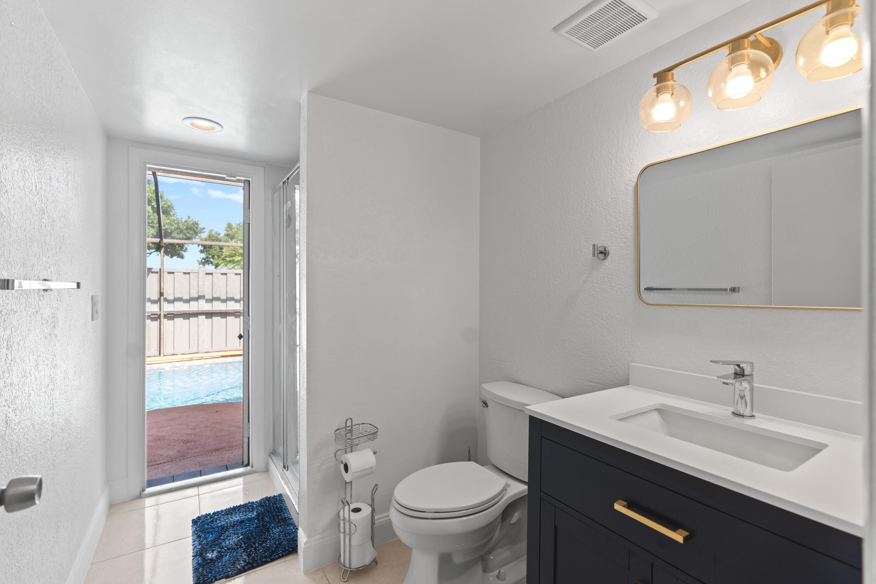 9927 Boca Gardens Trail, Unit A Boca Raton, FL 33496 - Photo 36 of 63 a bathroom with a toilet a sink and mirror