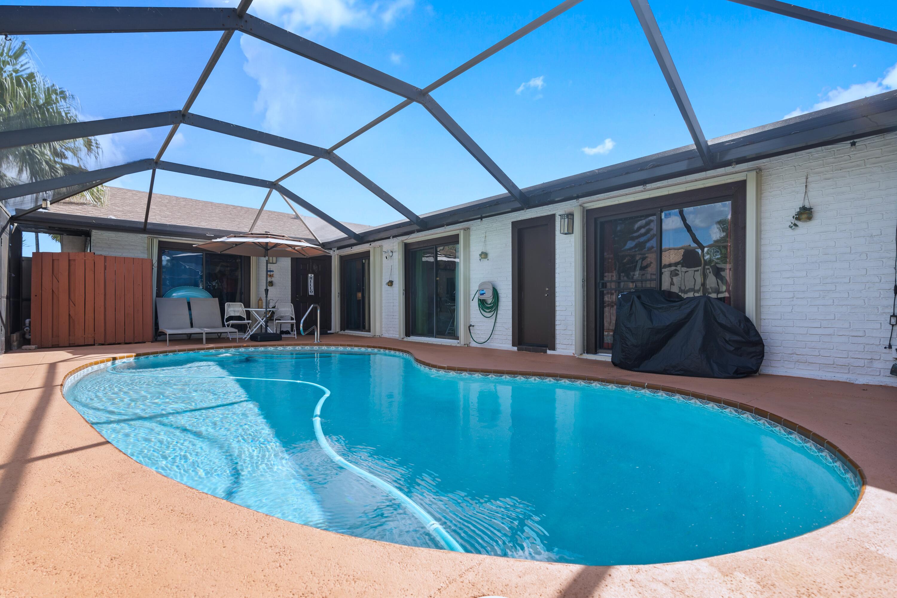 9927 Boca Gardens Trail, Unit A Boca Raton, FL 33496 - Photo 37 of 63 a view of a swimming pool with seating area