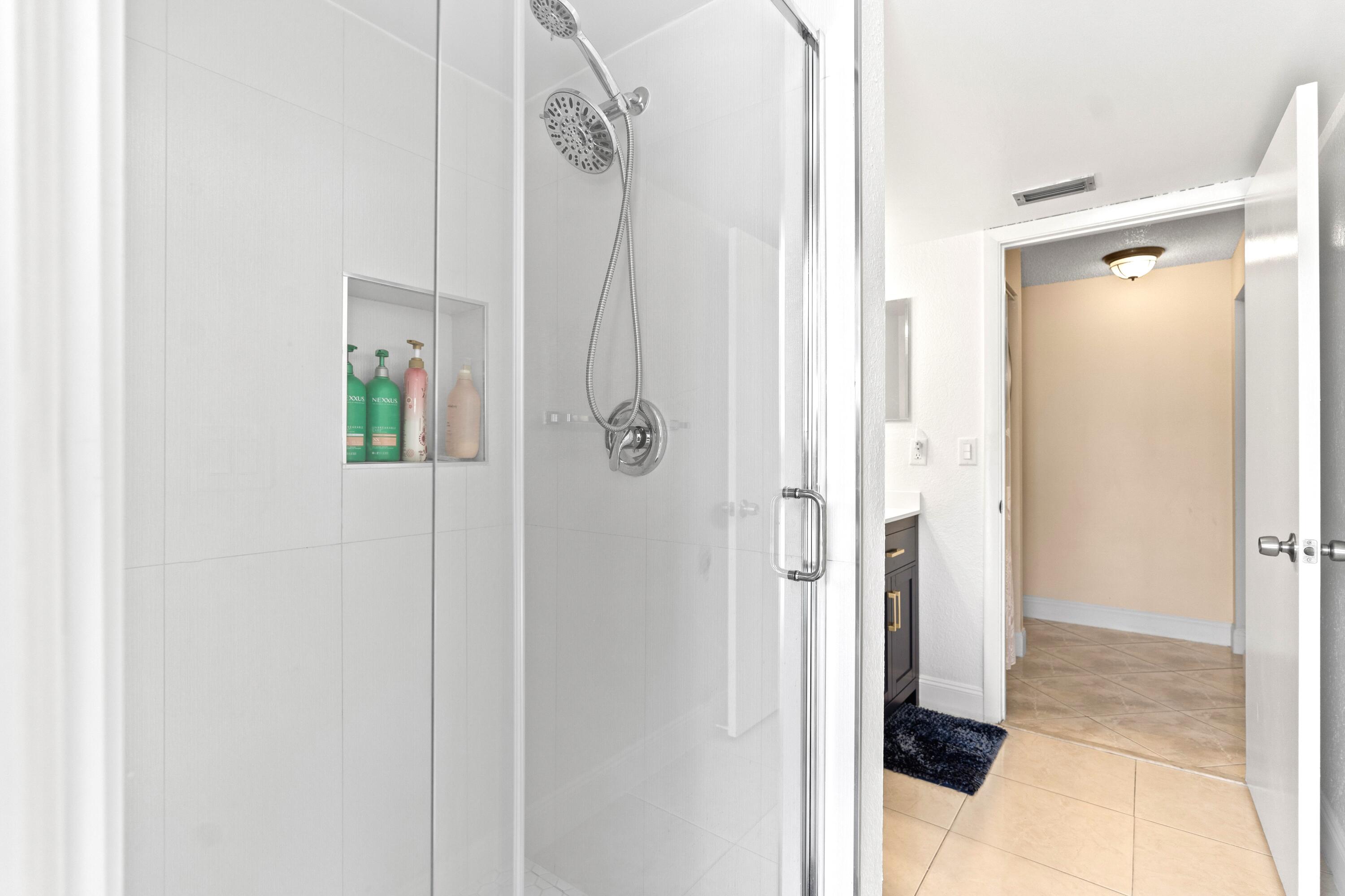 9927 Boca Gardens Trail, Unit A Boca Raton, FL 33496 - Photo 38 of 63 a bathroom with a shower and a sink