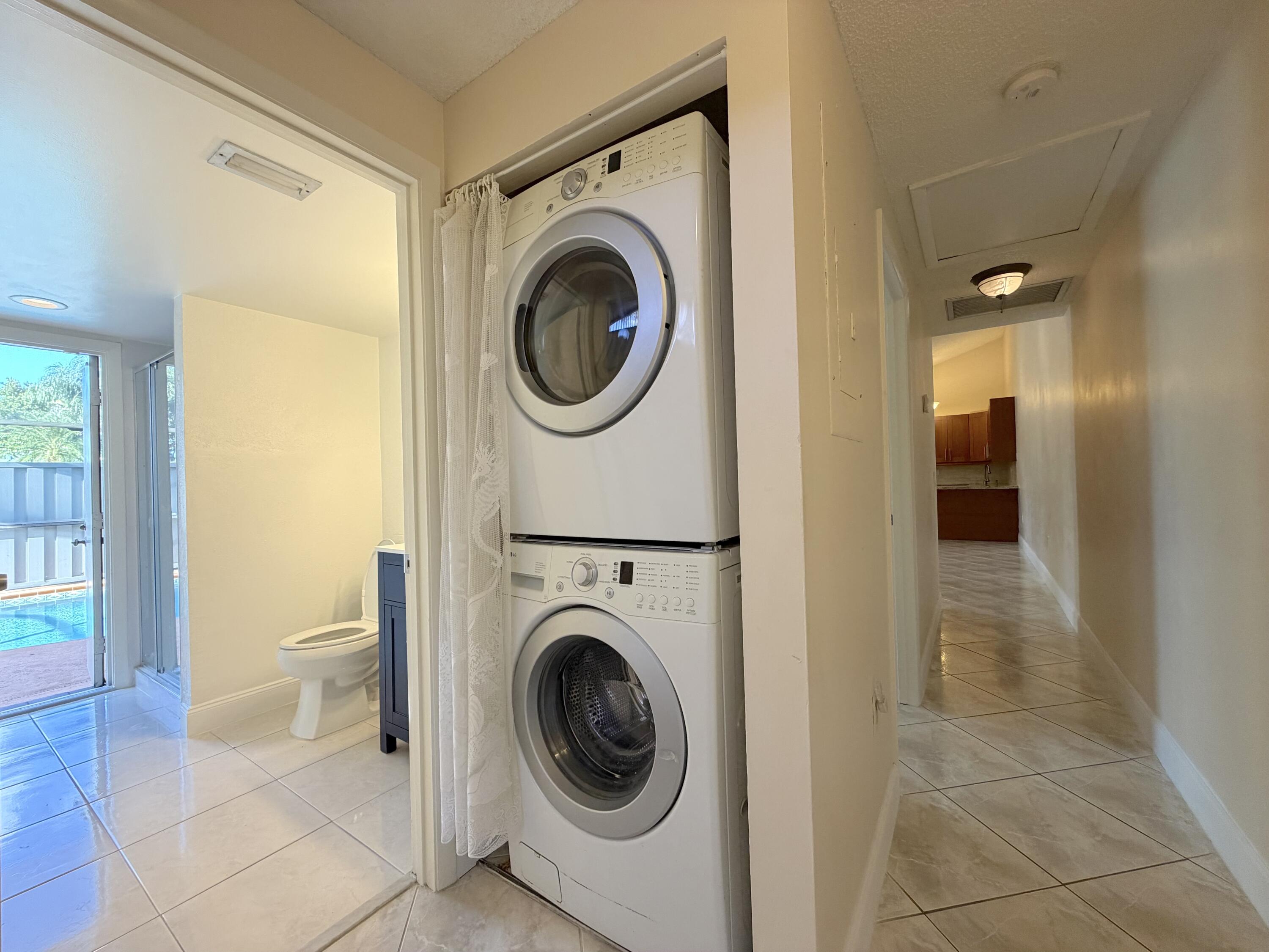 9927 Boca Gardens Trail, Unit A Boca Raton, FL 33496 - Photo 41 of 63 a view of a hallway with washer and dryer