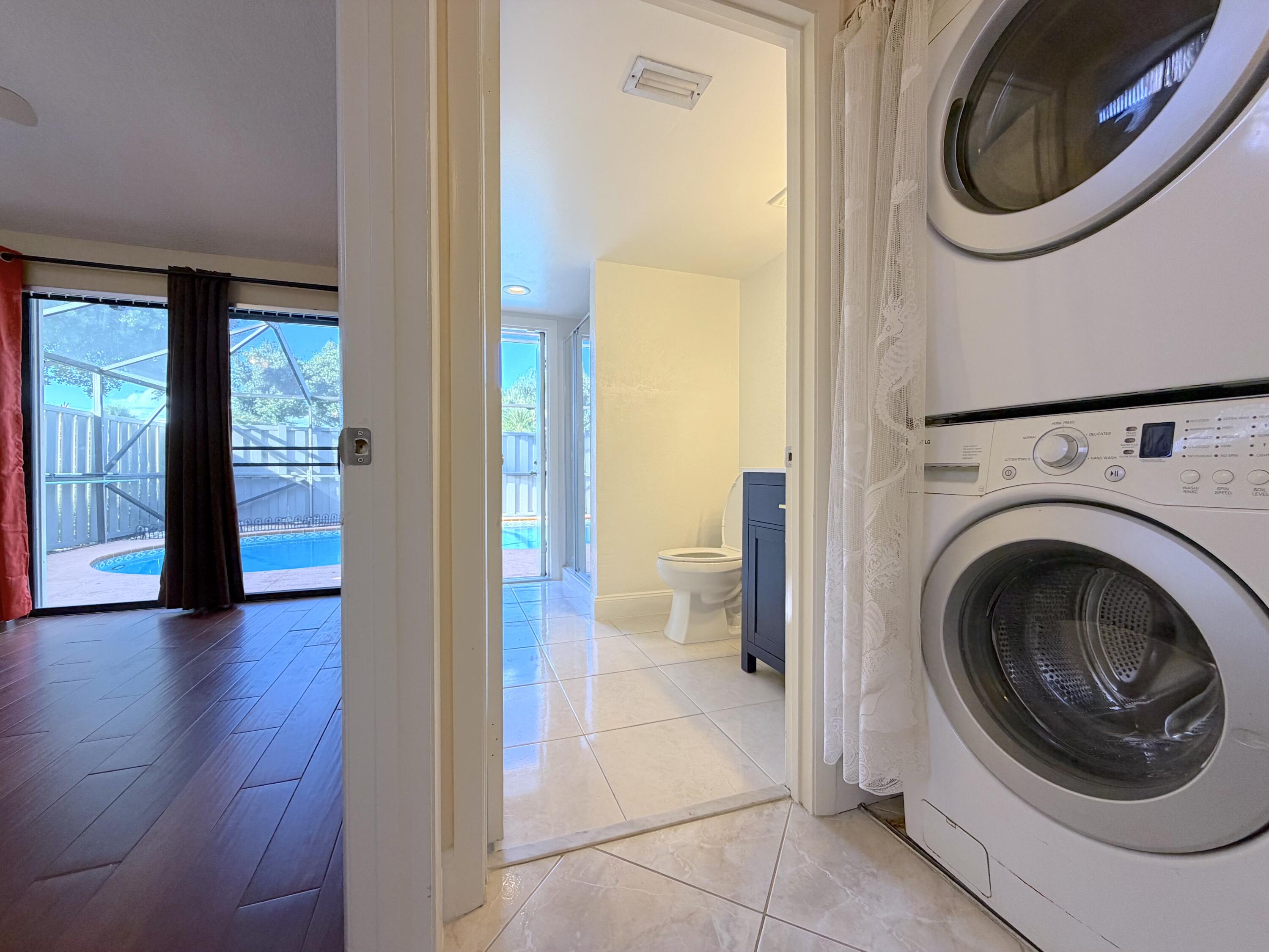 9927 Boca Gardens Trail, Unit A Boca Raton, FL 33496 - Photo 43 of 63 a view of a hallway with washer and dryer