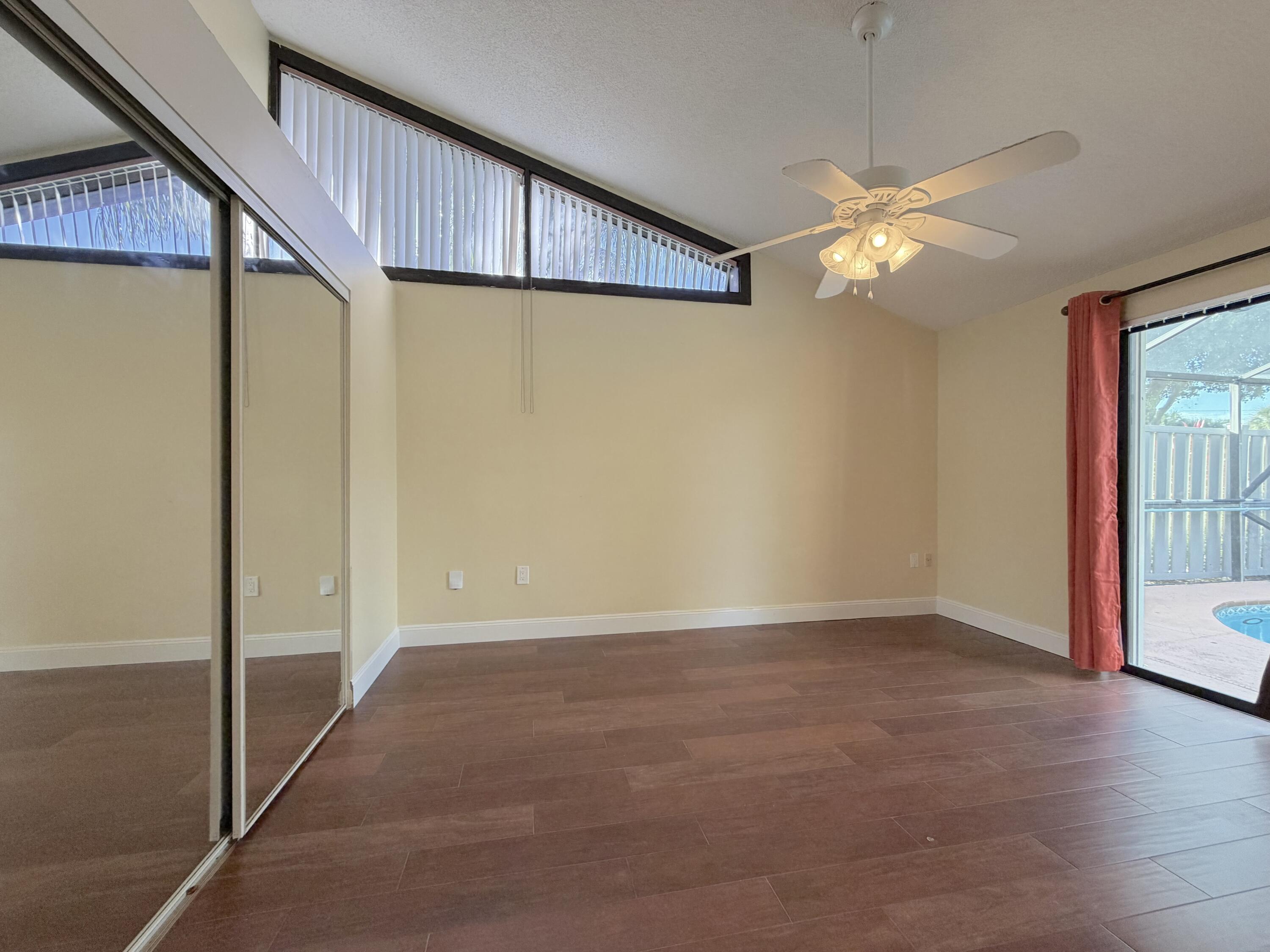 9927 Boca Gardens Trail, Unit A Boca Raton, FL 33496 - Photo 49 of 63 a view of an empty room with a fan