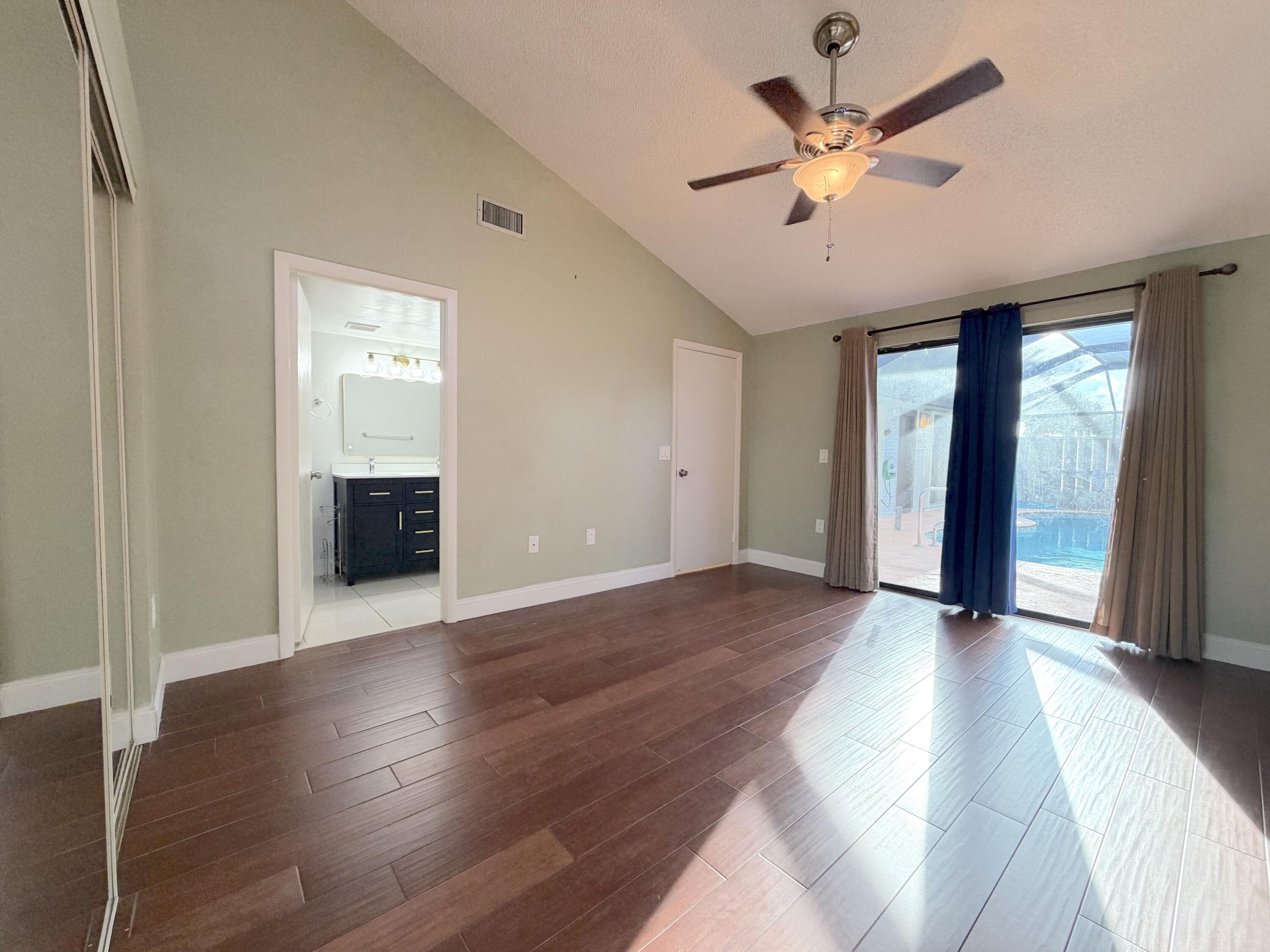 9927 Boca Gardens Trail, Unit A Boca Raton, FL 33496 - Photo 9 of 63 a view of a livingroom with a ceiling fan and wooden floor