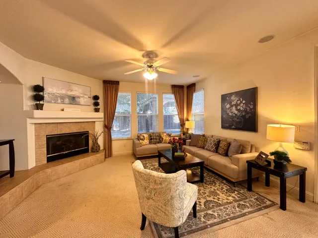 a living room with furniture fireplace and flat screen tv