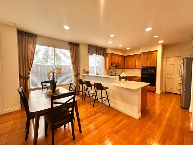 a kitchen with a sink a counter top space stainless steel appliances and a large window