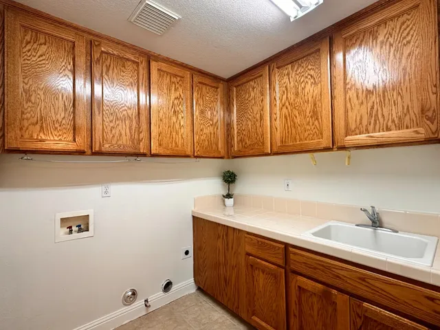 a bathroom with a granite countertop bathtub sink mirror vanity and toilet