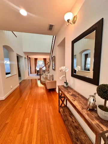a living room with furniture and a wooden floor