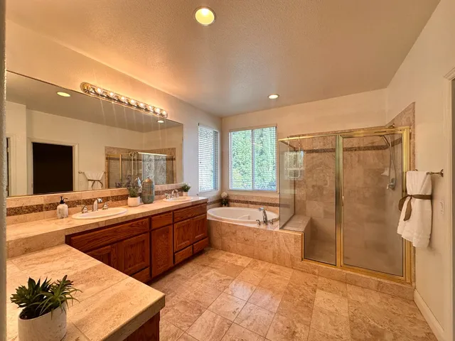 a large kitchen with a large counter top and stainless steel appliances