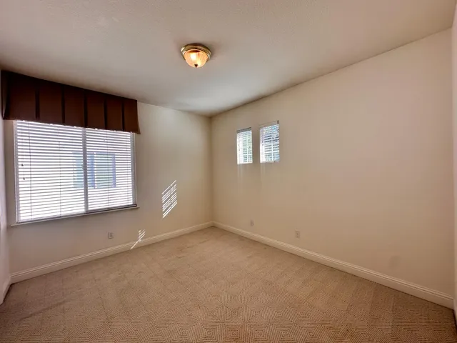 a bathroom with a double vanity sink toilet and a mirror