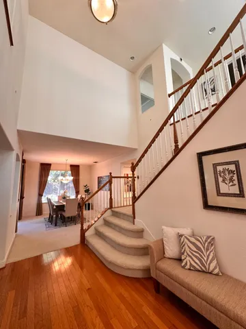 a living room with furniture and stairs