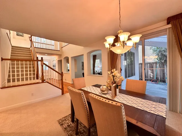 a living room with furniture and stairs