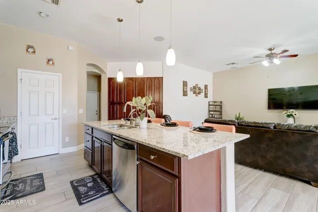 a view of kitchen island sink and living room
