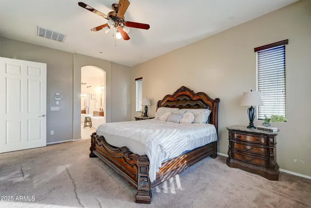 a bedroom with a bed and a chandelier