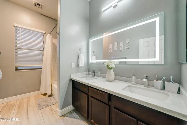 a bathroom with a granite countertop sink a large mirror and a