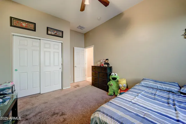 a bedroom with bed and wooden floor