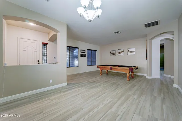 a view of room with wooden floor and ceiling fan