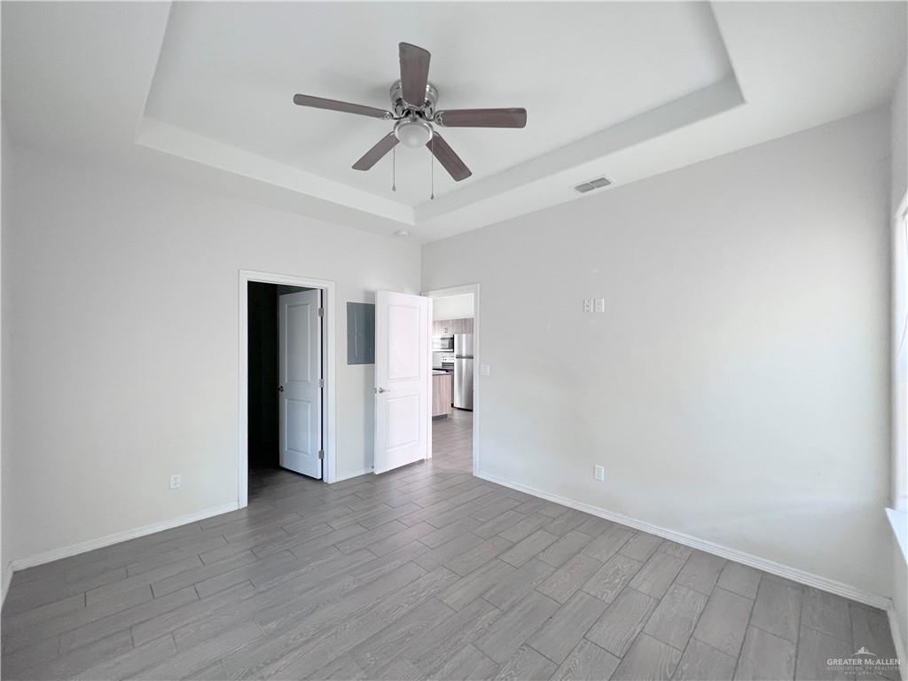 1609 West Cortlandt Street, Unit 3 Edinburg, TX 78541 - Photo 11 of 21 a view of a livingroom with wooden floor and a ceiling fan
