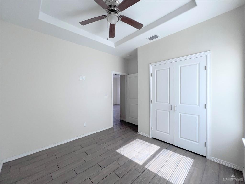 1609 West Cortlandt Street, Unit 3 Edinburg, TX 78541 - Photo 17 of 21 an empty room with ceiling fan and windows