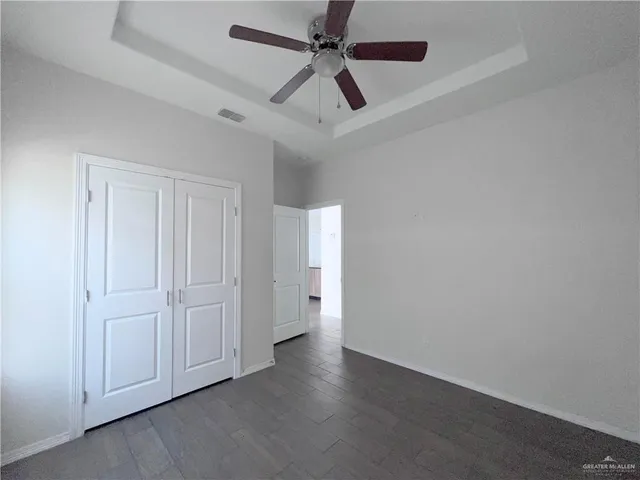 an empty room with a ceiling fan