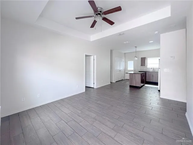 a view of a kitchen with a sink and a refrigerator