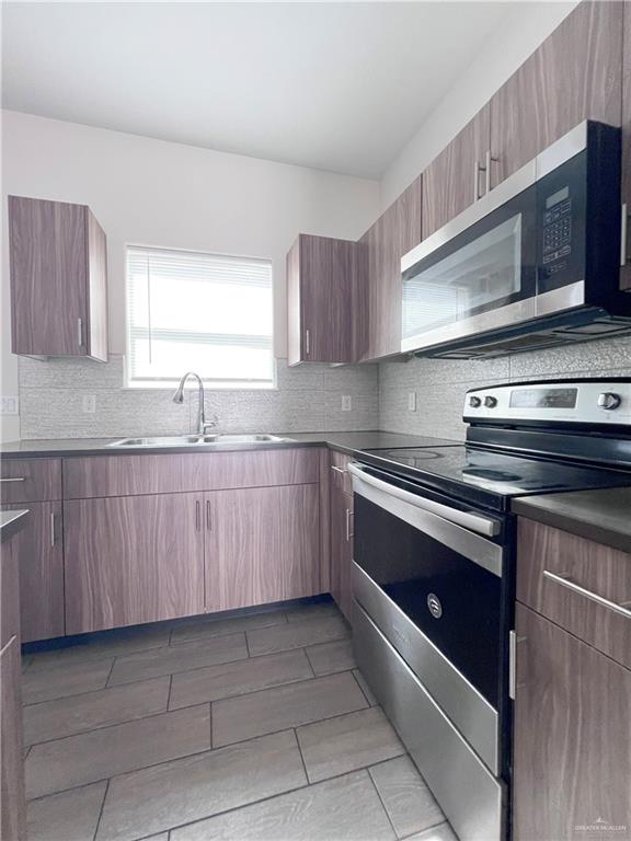 1609 West Cortlandt Street, Unit 3 Edinburg, TX 78541 - Photo 6 of 21 a kitchen with a sink stove top oven and cabinets